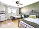 A bedroom with two twin beds, a ceiling fan, and a window at 5327 David Cir, Covington, GA 30014