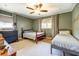Cozy bedroom with two twin beds, neutral decor, ceiling fan, and a large window at 5327 David Cir, Covington, GA 30014