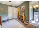 View of a cozy bedroom featuring a white rug, full size bed, and a view to a clean bathroom with a walk in shower at 5327 David Cir, Covington, GA 30014