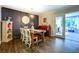 Dining room featuring modern chandelier, piano and hutch bookcase, wooden floors at 5327 David Cir, Covington, GA 30014