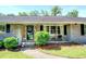 Close-up of a welcoming front porch with a decorative wreath, chairs, and landscaped details at 5327 David Cir, Covington, GA 30014