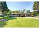 Inviting one-story brick home with a lush front yard, mature trees, and a welcoming entrance at 5327 David Cir, Covington, GA 30014