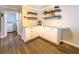 Kitchen area featuring granite countertops, white cabinetry and view into laundry room at 5327 David Cir, Covington, GA 30014