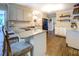 Modern kitchen with granite countertops, white cabinetry, hardwood floors, and bar stool seating at 5327 David Cir, Covington, GA 30014