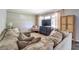 Comfortable living room featuring plush furniture, a large window, and a modern TV at 5327 David Cir, Covington, GA 30014