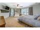 Spacious main bedroom boasts a ceiling fan, large windows, and a cozy sitting area with a white loveseat at 5327 David Cir, Covington, GA 30014