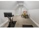 Finished attic room with neutral carpet, bright white trim, and a charming miniature house on display at 5850 Overlook Rdg, Suwanee, GA 30024