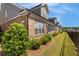 Backyard featuring landscaped green space, brick exterior, and screened windows at 5850 Overlook Rdg, Suwanee, GA 30024