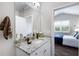 Bathroom featuring a granite countertop vanity and view into bedroom area at 5850 Overlook Rdg, Suwanee, GA 30024
