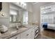 Large bathroom featuring double sinks, granite counters, tile floors, and connected bedroom at 5850 Overlook Rdg, Suwanee, GA 30024