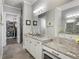 Large bathroom featuring double sinks, granite counters, tile floors, and a walk-in closet at 5850 Overlook Rdg, Suwanee, GA 30024