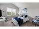 Cozy bedroom with a large window, neutral color scheme, and stylish blue accents in the decor at 5850 Overlook Rdg, Suwanee, GA 30024