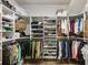 Walk in closet with custom shelving, ample storage, and organized hanging space at 5850 Overlook Rdg, Suwanee, GA 30024