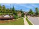 Community entrance with stone sign, manicured landscaping, and secure gated entry at 5850 Overlook Rdg, Suwanee, GA 30024