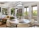 Elegant dining area with natural light, a modern chandelier and view of the outdoors at 5850 Overlook Rdg, Suwanee, GA 30024