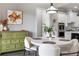 Dining area featuring modern table and chairs, colorful art and cabinetry at 5850 Overlook Rdg, Suwanee, GA 30024