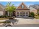 Charming brick home featuring a two-car garage and manicured landscaping, creating an inviting curb appeal at 5850 Overlook Rdg, Suwanee, GA 30024