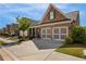 Beautiful brick home with a well-maintained lawn and a two-car garage, set against a sunny sky at 5850 Overlook Rdg, Suwanee, GA 30024