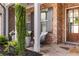 Inviting front porch with seating, showcasing the home's brick facade and well-maintained landscaping at 5850 Overlook Rdg, Suwanee, GA 30024