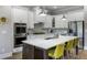 Modern kitchen featuring a spacious island with seating, stainless steel appliances, and ample counter space at 5850 Overlook Rdg, Suwanee, GA 30024