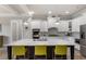 Well-appointed kitchen with a large island, white cabinets, and modern stainless steel appliances at 5850 Overlook Rdg, Suwanee, GA 30024