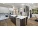 Spacious kitchen with a center island, stainless steel appliances, and a view of the staircase at 5850 Overlook Rdg, Suwanee, GA 30024