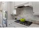 Modern kitchen with stainless steel appliances, marble backsplash, and granite countertops at 5850 Overlook Rdg, Suwanee, GA 30024