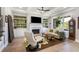 Cozy living room with a fireplace, built-in shelves, and hardwood floors at 5850 Overlook Rdg, Suwanee, GA 30024