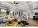 Open-concept living and dining area with hardwood floors and lots of natural light at 5850 Overlook Rdg, Suwanee, GA 30024