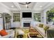 Bright living room with fireplace, built-in shelving, and hardwood floors at 5850 Overlook Rdg, Suwanee, GA 30024