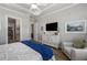 Bright main bedroom featuring a tray ceiling, hardwood floors, and an ensuite bath and closet at 5850 Overlook Rdg, Suwanee, GA 30024