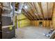 Spacious unfinished attic with exposed wood frame, insulated walls, and a small window at 5850 Overlook Rdg, Suwanee, GA 30024