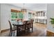 Cozy dining room with wood floors, pendant lighting, and large windows offering natural light at 685 Maplelake Dr, Acworth, GA 30101