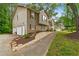 Charming split-level home featuring a two-car garage, wood siding, and manicured landscaping at 685 Maplelake Dr, Acworth, GA 30101