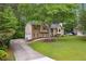 Traditional-style home with an attached two-car garage, well-maintained lawn, and mature trees at 685 Maplelake Dr, Acworth, GA 30101