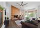 Bright living room with a wood accent wall, fireplace, and a bay window at 685 Maplelake Dr, Acworth, GA 30101