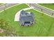 Aerial view of a modern two-story home on a lush green lot with a long driveway at 17145 River Overlook Dr, Roswell, GA 30075