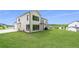 Sprawling backyard features green grass, a patio, and the back of the two-story home at 17145 River Overlook Dr, Roswell, GA 30075