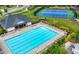 Aerial view of a community pool, tennis court, lounge chairs, and community buildings at 17145 River Overlook Dr, Roswell, GA 30075