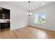 Dining area with hardwood floors and a bar area featuring natural light at 17145 River Overlook Dr, Roswell, GA 30075
