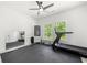 Home gym with rubber floors, a treadmill, full mirror, and windows providing natural light and views at 17145 River Overlook Dr, Roswell, GA 30075