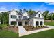 Stunning two-story white brick home featuring black window shutters and a beautifully landscaped front yard at 17145 River Overlook Dr, Roswell, GA 30075
