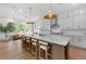 Gourmet kitchen features a large center island, stainless steel appliances, ample cabinets, and hardwood flooring at 17145 River Overlook Dr, Roswell, GA 30075