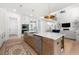 Open concept kitchen with a large center island, stainless steel appliances, and seamless access to the living room at 17145 River Overlook Dr, Roswell, GA 30075