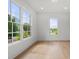 Sunlit living room with hardwood floors and big windows at 17145 River Overlook Dr, Roswell, GA 30075