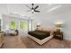 Spacious main bedroom with hardwood floors, large windows, and a comfortable seating area at 17145 River Overlook Dr, Roswell, GA 30075
