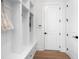 Mudroom with built-in storage cubbies, bench, and coat hooks for organization and convenience at 17145 River Overlook Dr, Roswell, GA 30075