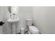 Clean powder room features a pedestal sink, toilet, and hardwood floors at 17145 River Overlook Dr, Roswell, GA 30075