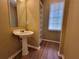 Cozy bathroom with pedestal sink, built-in shelving, and a bright window at 1745 Collines Sw Ave, Atlanta, GA 30331