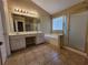Bathroom with dual vanities, a large soaking tub, and a separate shower at 1745 Collines Sw Ave, Atlanta, GA 30331